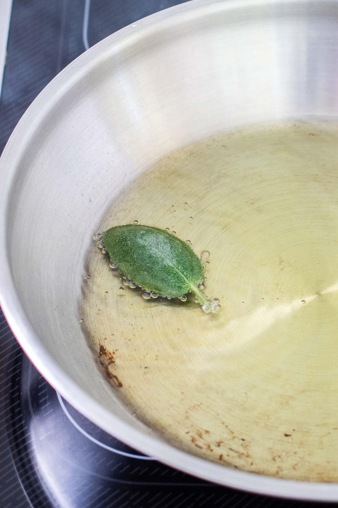Test to see if the oil is hot enough (or too hot!) by. adding 1 sage leaf.