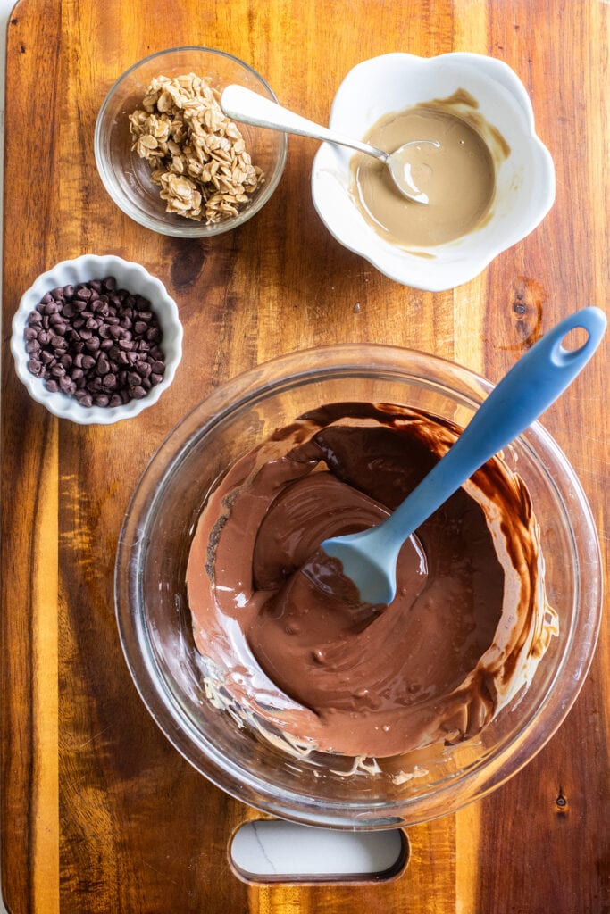 Melted chocolate, SunButter, mini chocolate chips, and a little bowl of the oatmeal mixture to use as toppings.