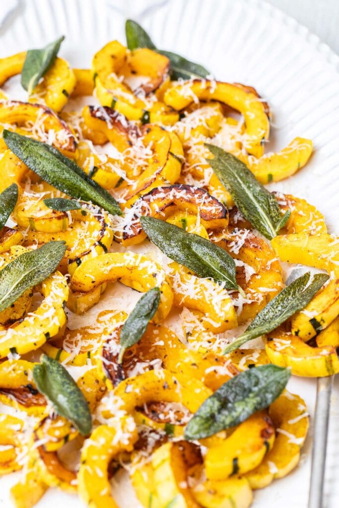 Sauteed winter squash shown garnished with sage leaves.