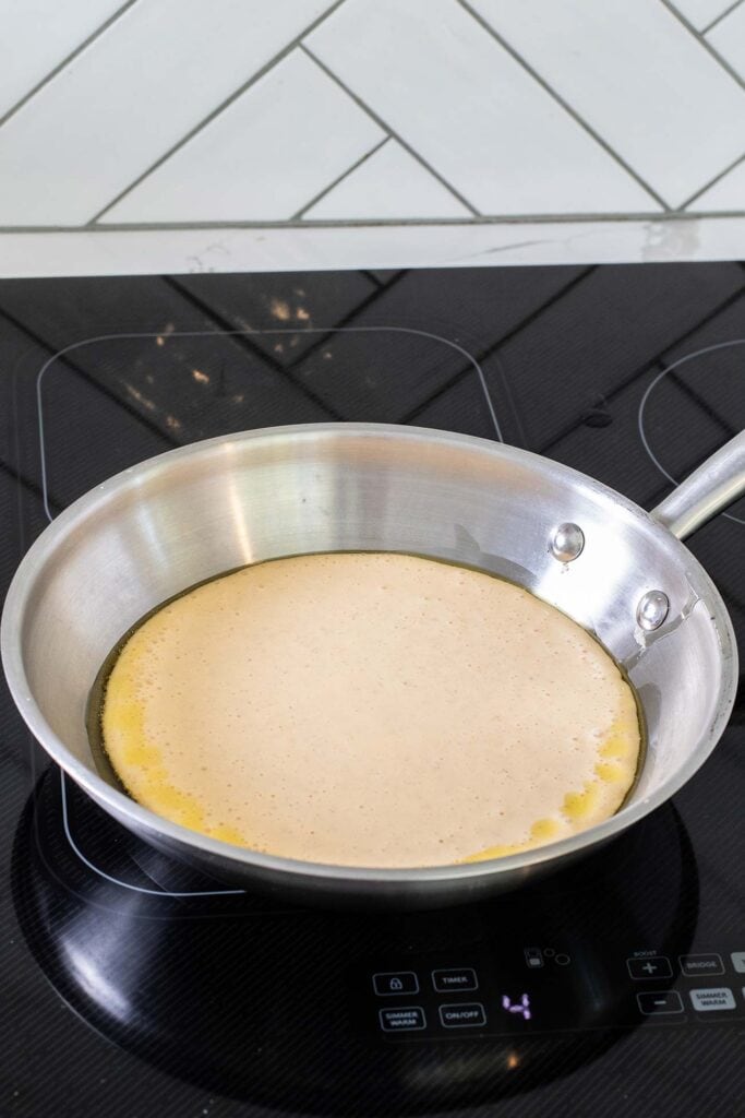 Pancake batter added to a hot skillet.