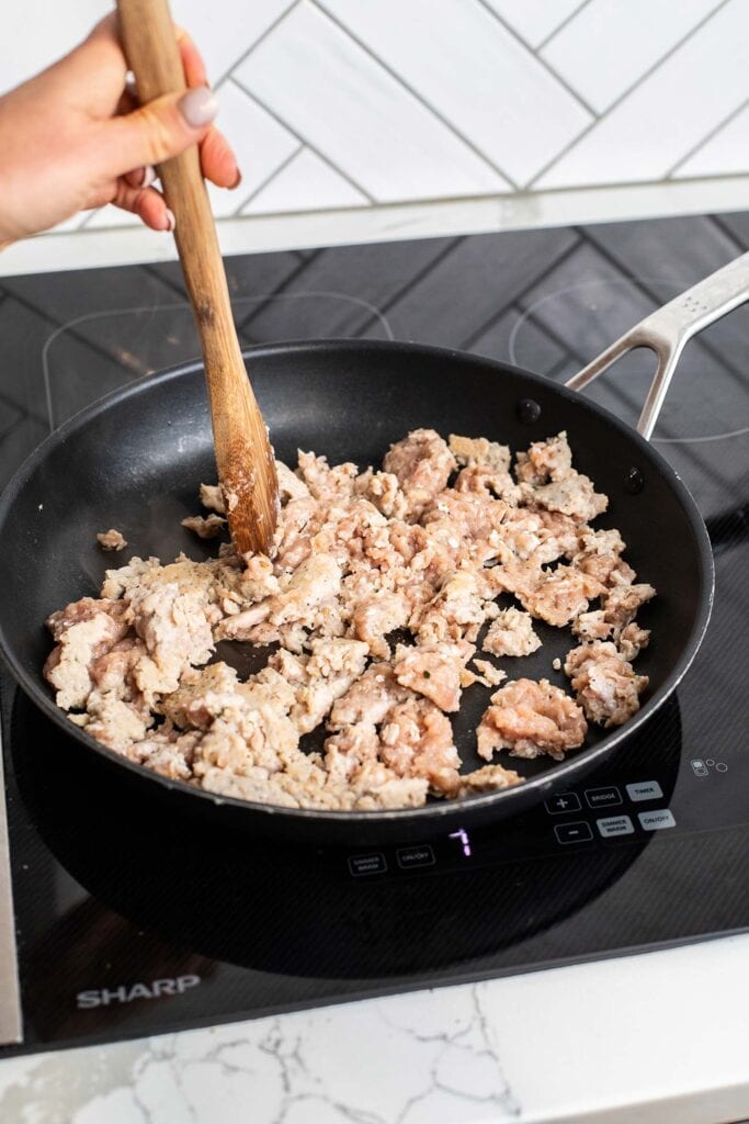 Sausage cooking in a skillet.