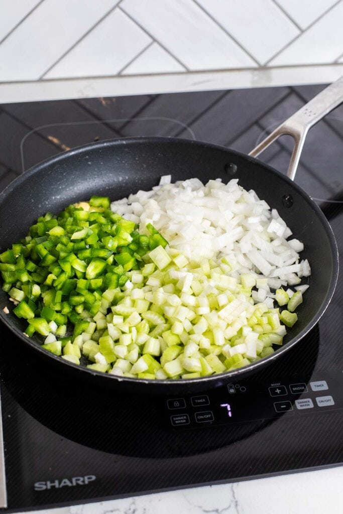 Vegetables and apple added to the skillet.
