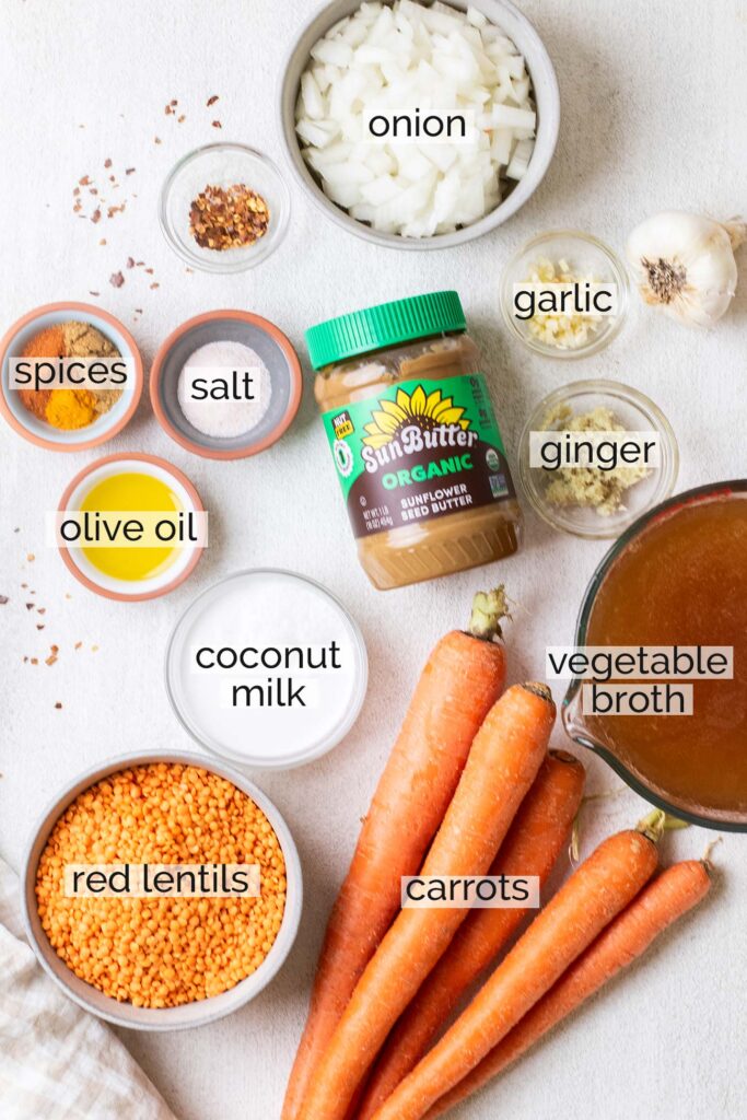 The ingredients needed to make a red lentil carrot soup.