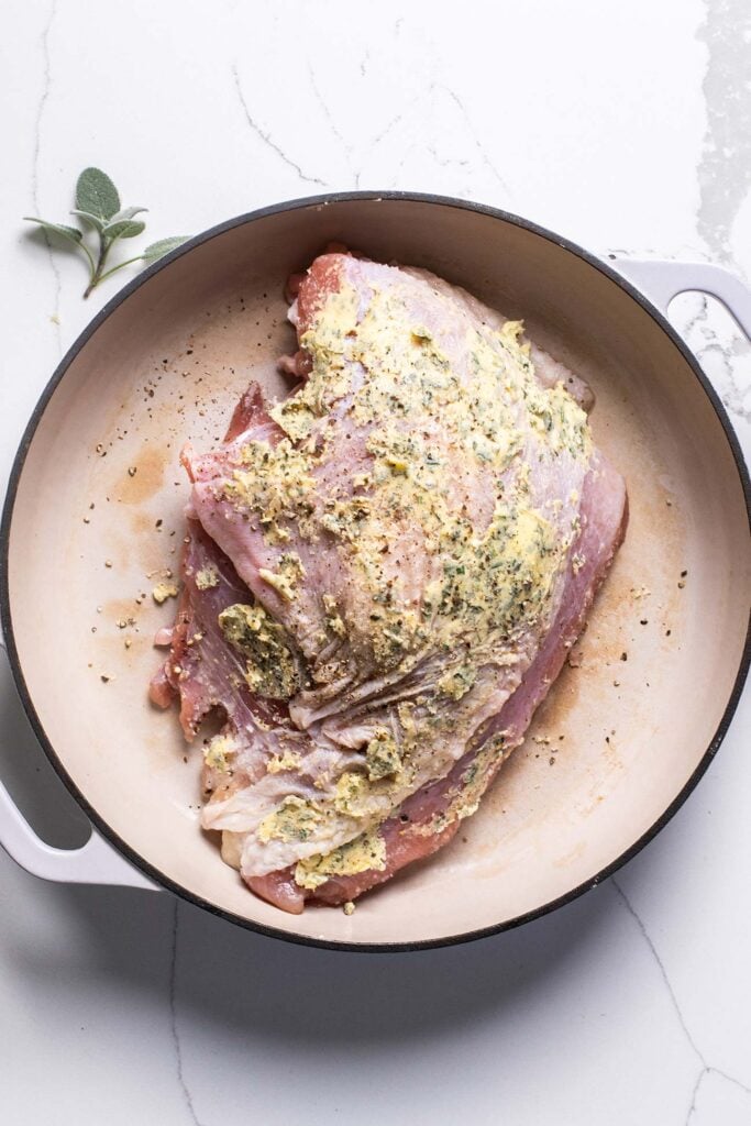 A turkey breast coated in an herb butter.