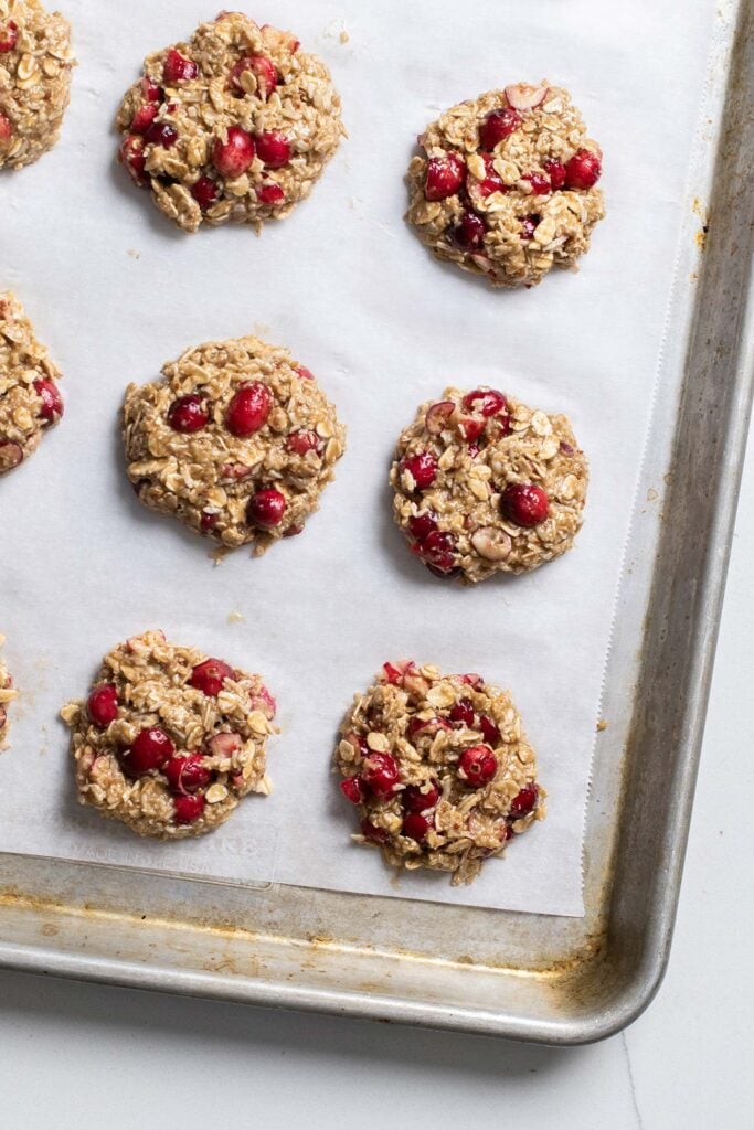 Mounds of cookie dough on a baking sheet.