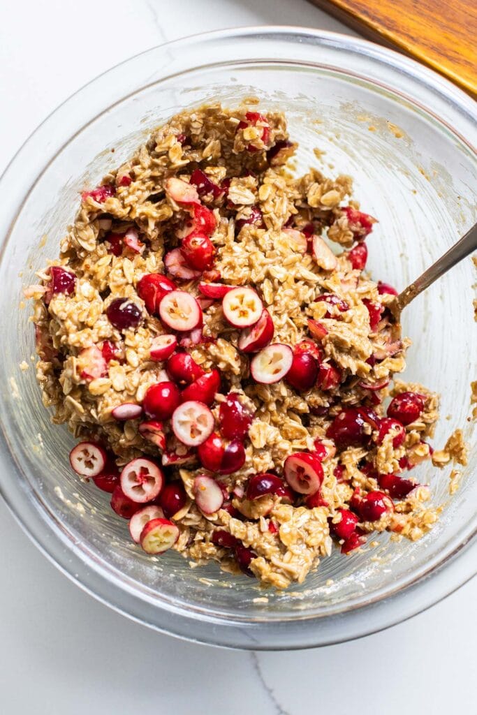 Cranberries folded into oatmeal cookie dough.