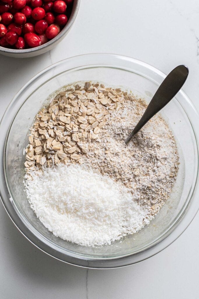 Oats and coconut added to the wet ingredients.
