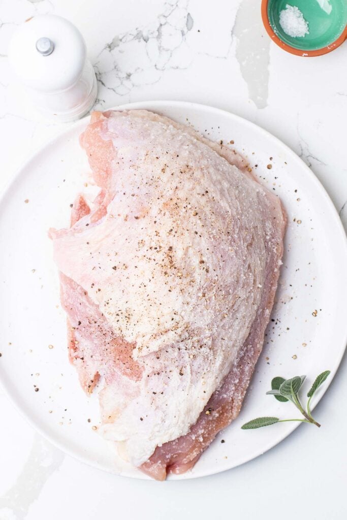 Turkey breast seasoned with salt and pepper.