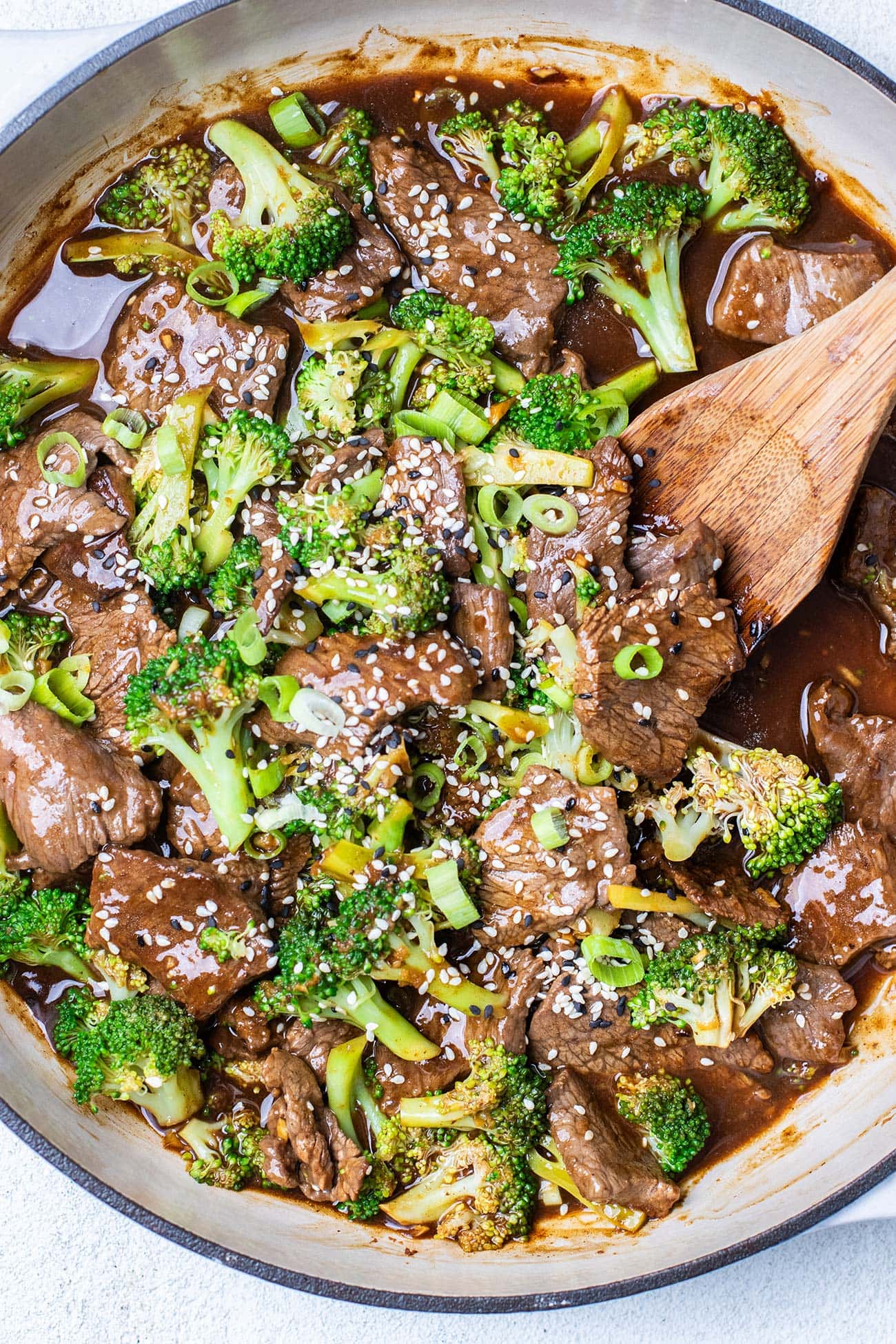 Beef and broccoli garnished with sesame seeds and green onions.