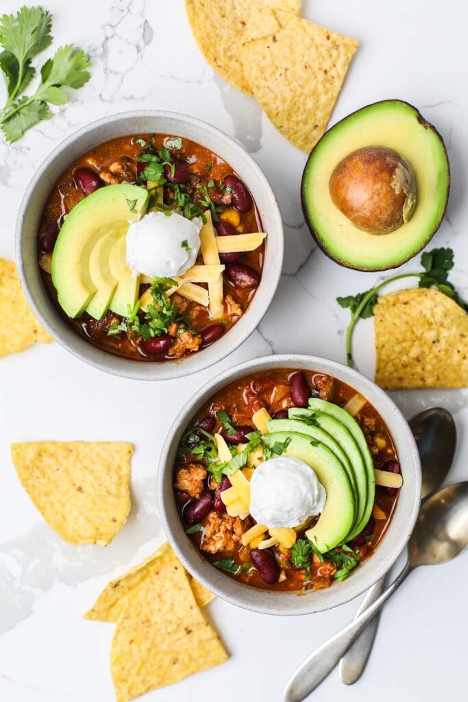 Serve the chili with toppings.