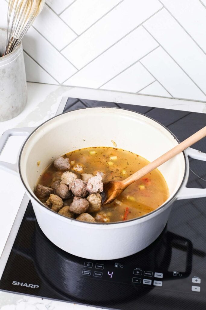 Add chicken broth and turkey meatballs.