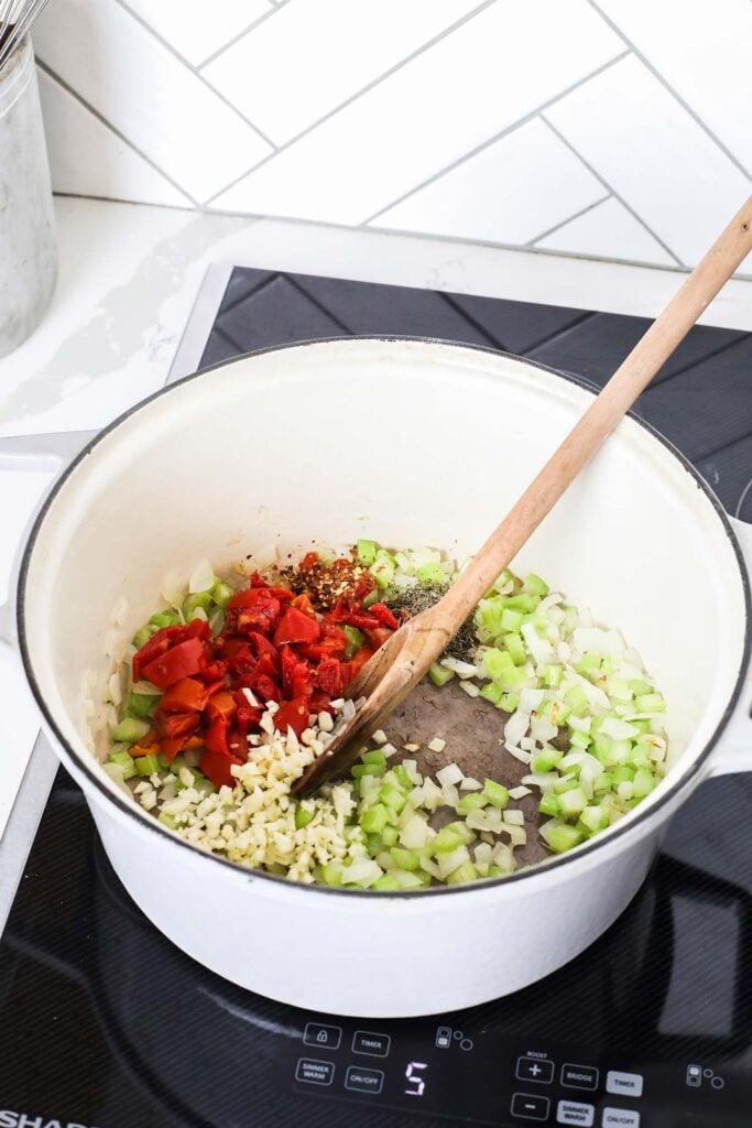 Sundried tomatoes and garlic added into the pot with the vegetables.