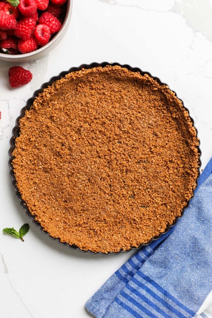 Graham cracker crumbs pressed into a tart pan.
