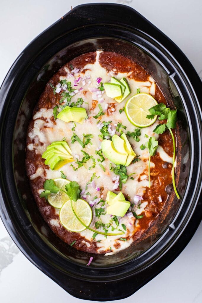Red onion, avocado, and cilantro added to the top of the chicken and rice dish.
