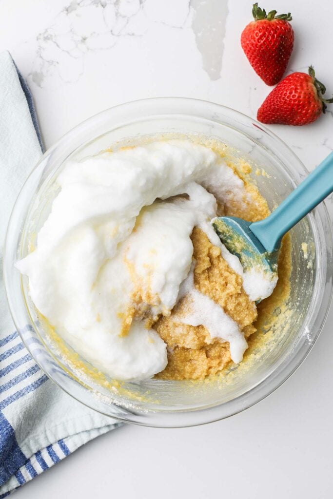 Egg whites being carefully folded into the cake batter.
