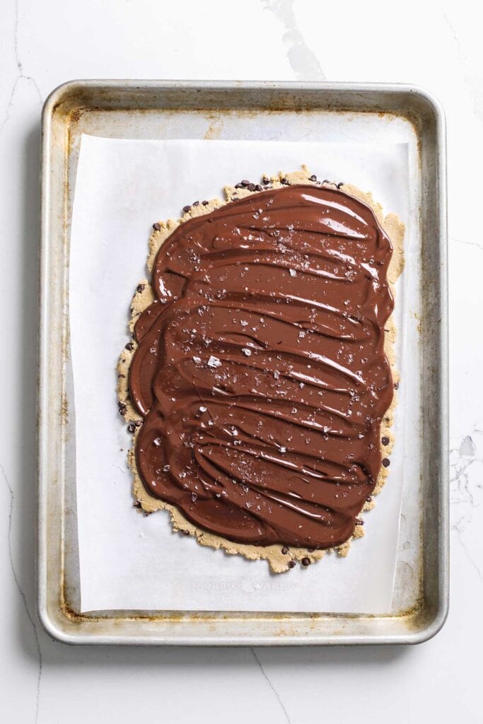 A thin layer of chocolate spread out over the cookie dough layer.