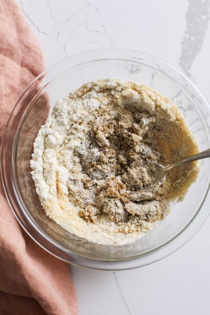 A dry, dense cookie dough shown in a bowl.