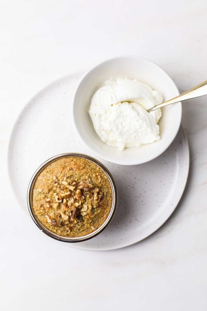 Zucchini baked oats next to a bowl of Greek yogurt.