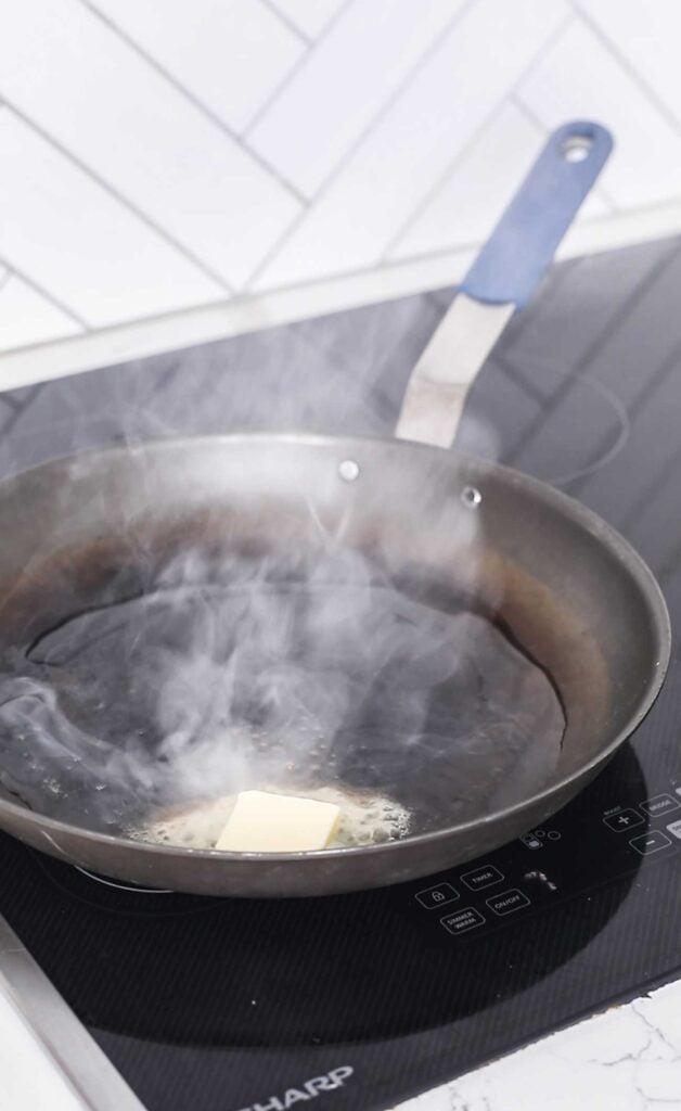 A carbon steel pan smoking hot with butter and olive oil.