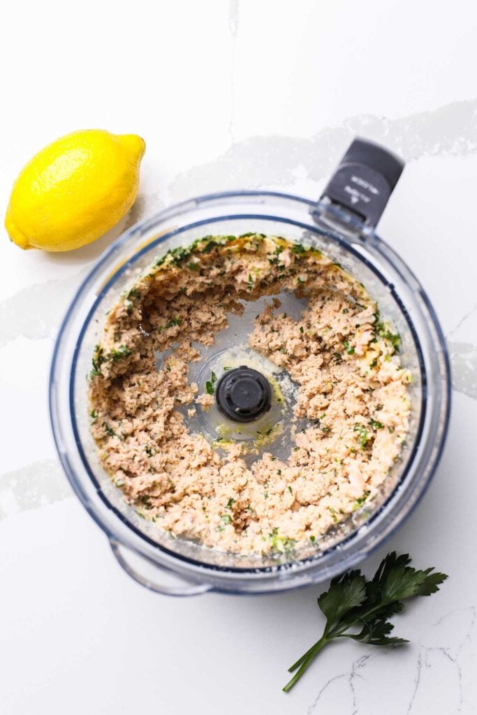 The ingredients for easy salmon patties shown in a food processor bowl.
